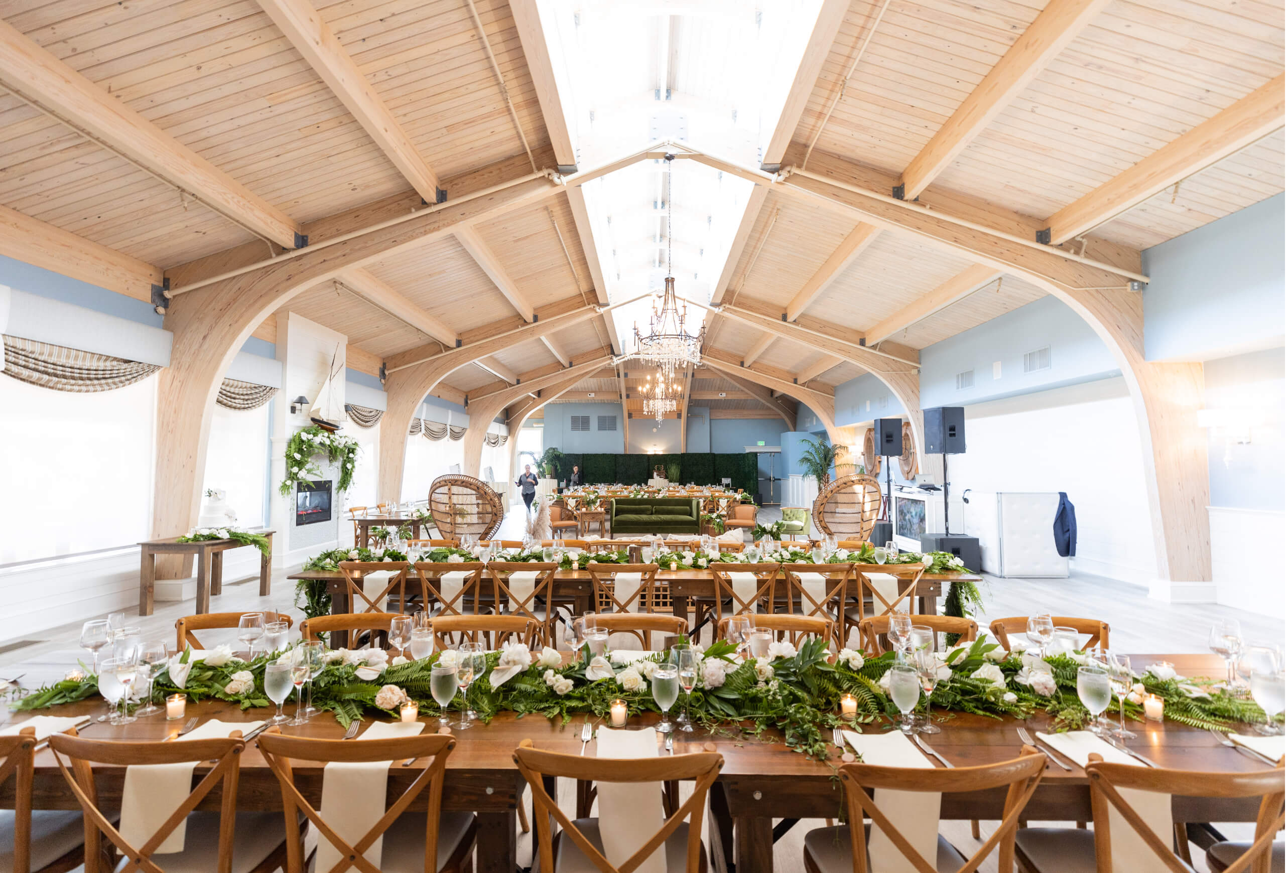 a large, brightly lit dining room with round tables set for a meal
