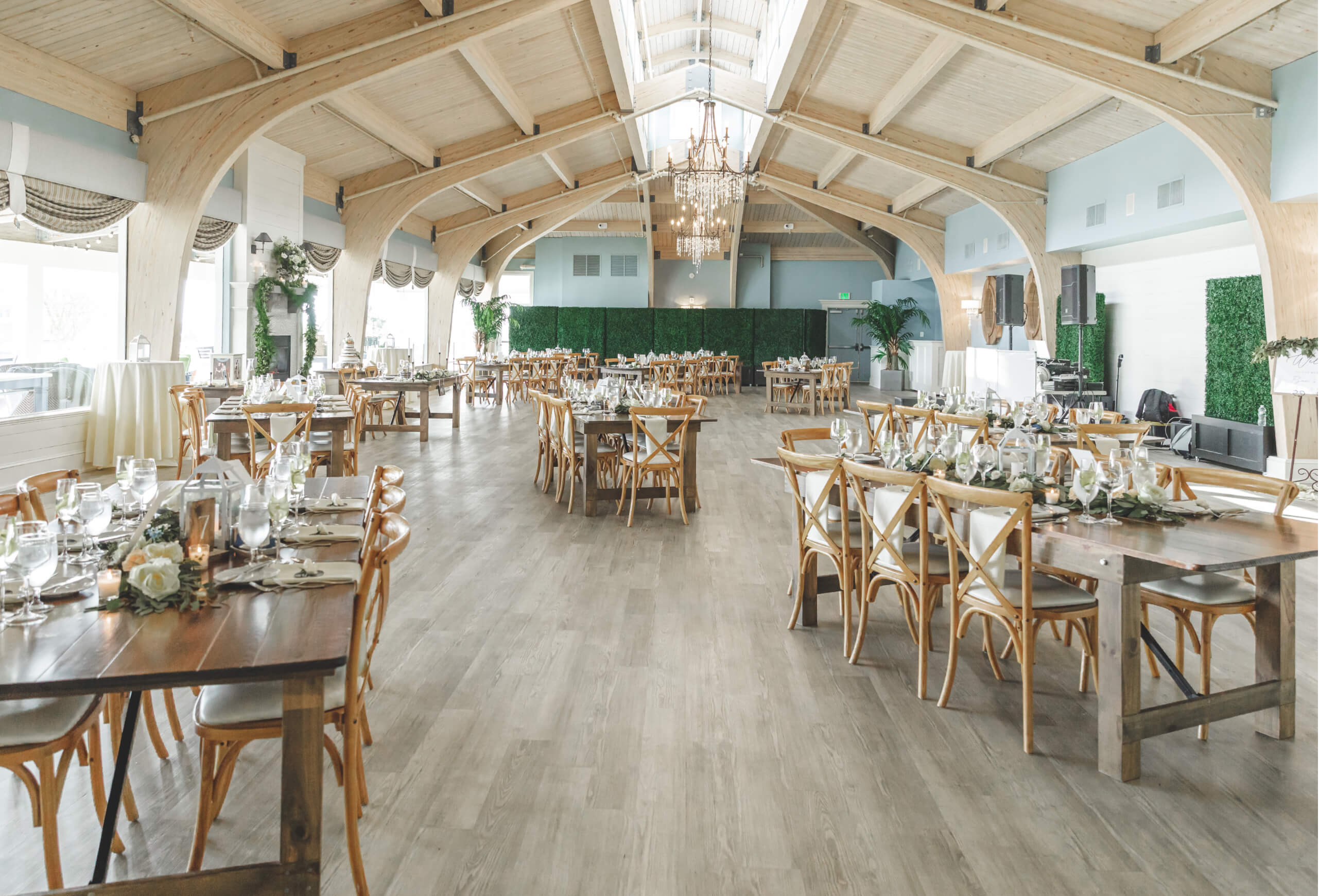 a large room with arched ceiling and chandelier set for a formal event